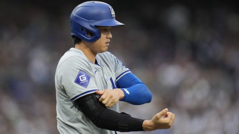 Los Angeles Dodgers' Shohei Ohtani adjusts an arm brace after walking during the sixth inning of a baseball game against the San Diego Padres, Saturday, May 11, 2024, in San Diego. (AP Photo/Gregory Bull)