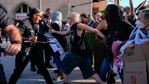 Police clash with pro-Palestinian demonstrators at the Shrine Auditorium, where a commencement ceremony for graduates from Pomona College was being held Sunday, May 12, 2024, in Los Angeles. (AP Photo/Ryan Sun)