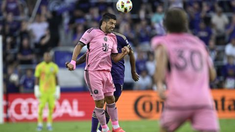 Inter Miami forward Luis Suarez (9) heads the ball in front of Orlando City midfielder Wilder Cartagena during the first half of an MLS soccer match, Wednesday, May 15, 2024, in Orlando, Fla. (AP Photo/Phelan M. Ebenhack)