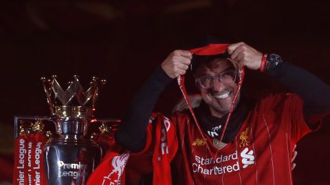 FILE - Liverpool's manager Jurgen Klopp puts on his winner medal prior to his team lifting the English Premier League trophy following the English Premier League soccer match between Liverpool and Chelsea at Anfield Stadium in Liverpool, England, Wednesday, July 22, 2020. Jurgen Klopp is preparing for his final game as Liverpool manager after nine years in charge. He says it has been “the most intense week of my life” as he bids goodbye to players, club staff and fans. (Phil Noble/Pool via AP, File)