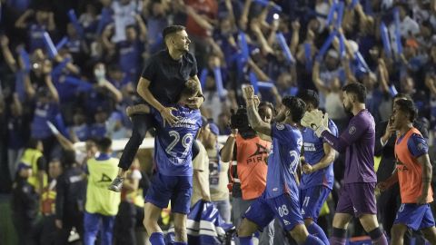 Cruz Azul coach Martin Anselmi, top, and his players celebrate at the end of a Mexican soccer league semifinal second-leg match in Mexico City, Sunday, May 19, 2024. Monterrey won 2-1 but Cruz Azul advance on aggregate. (AP Photo/Eduardo Verdugo)