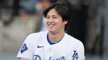Los Angeles Dodgers' Shohei Ohtani smiles in the dugout before a baseball game against the Arizona Diamondbacks, Tuesday, May 21, 2024, in Los Angeles. (AP Photo/Marcio Jose Sanchez)