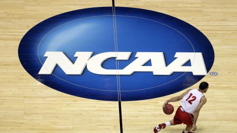 FILE - Wisconsin's Traevon Jackson dribbles past the NCAA logo during practice at the NCAA men's college basketball tournament March 26, 2014, in Anaheim, Calif. The NCAA and the nation's five biggest conferences have agreed to pay nearly $2.8 billion to settle a host of antitrust claims,a monumental decision that sets the stage for a groundbreaking revenue-sharing model that could start directing millions of dollars directly to athletes as soon as the 2025 fall semester. (AP Photo/Jae C. Hong, File)