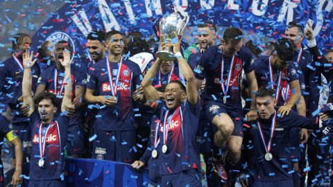 PSG's Kylian Mbappe raises the trophy during the presentation ceremony after the French Cup final soccer match between Lyon and PSG at the Pierre Mauroy stadium in Villeneuve d'Ascq, northern France, Saturday, May 25, 2024. PSG won the match 2-1. (AP Photo/Michel Euler)