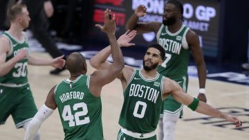 Boston Celtics forward Jayson Tatum (0) celebrates with teammate center Al Horford (42) during the second half of Game 3 of the NBA Eastern Conference basketball finals against the Indiana Pacers, Saturday, May 25, 2024, in Indianapolis. (AP Photo/Darron Cummings)