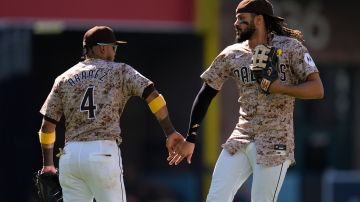 San Diego Padres right fielder Fernando Tatis Jr., right, celebrates with teammate first baseman Luis Arraez after the Padres defeated the New York Yankees 5-2 in a baseball game, Sunday, May 26, 2024, in San Diego. (AP Photo/Gregory Bull)