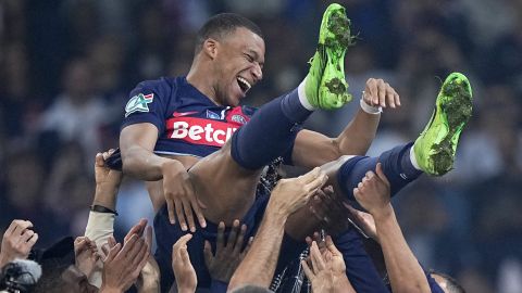 PSG's Kylian Mbappe is tossed into the air as he celebrates with teammates after the French Cup final soccer match between Lyon and PSG at the Pierre Mauroy stadium in Villeneuve d'Ascq, northern France, Saturday, May 25, 2024. PSG won the match 2-1. (AP Photo/Michel Euler)