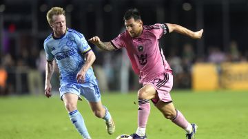 Inter Miami forward Lionel Messi, right, runs with the ball. during the first half of the team's MLS soccer match against Atlanta United on Wednesday, May 29, 2024, in Fort Lauderdale, Fla. (AP Photo/Lynne Sladky)