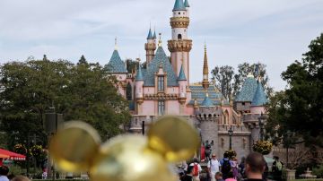 FILE - In this Jan. 22, 2015, file photo, people walk toward Sleeping Beauty's Castle at Disneyland in Anaheim, Calif. A measles outbreak that began at Disneyland and reignited debate about vaccinations is nearing an end. The outbreak will be declared over in California on Friday, April 17, 2015, if no new cases pop up, according to the California Department of Public Health. (AP Photo/Jae C. Hong, File)