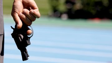 A race official holds a start gun prior to a Men's 800m heat during the European Athletics Championships, in Barcelona, Spain, Wednesday, July 28, 2010. (AP Photo/Anja Niedringhaus)