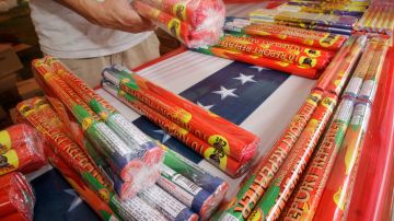 A worker places fireworks on a table before the opening of Fireworks World near Little Rock, Ark., Wednesday, June 22, 2011. (AP Photo/Danny Johnston)