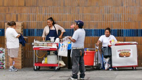 FILE - This Aug. 3, 2006 file photo shows street vendors in the Echo Park section of Los Angeles. Two members of the Los Angeles City Council want to legalize sidewalk vendors, arguing it will help people who fear deportation in the wake of President-elect Donald Trump's promise to ship out millions who are in the country illegally. Joe Buscaino and Curren Price sent a letter Tuesday, Nov. 22, 2016, to their fellow council members outlining a policy to decriminalize and regulate street vending. (AP Photo/Damian Dovarganes, File)