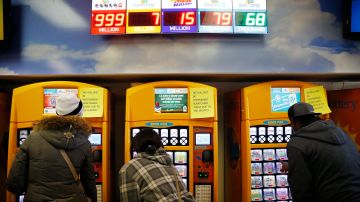 FILE - In this Jan. 12, 2016, file photo, people buy lottery tickets at the Primm Valley Casino Resorts Lotto Store just inside the California border near Primm, Nev. The California Lottery announced in June 2017 that a 19-year-old woman won a total of $655,555 on a pair of $5 scratch-off tickets purchased the same week. (AP Photo/John Locher, File)