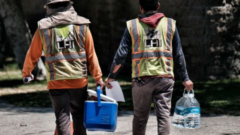 Construction workers carry large bottles of water during a break in the blistering days heat in downtown Los Angeles on Friday, July 6, 2018. Southern California baked Friday under a heat wave that forecasters correctly predicted would be one for the record books, with widespread triple-digit highs and increased fire danger. The National Weather Service says downtown Los Angeles broke the July 6, 1992 record when it hit 95 degrees. (AP Photo/Richard Vogel)