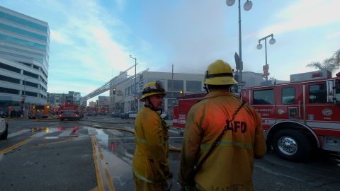 Los Angeles Fire Department firefighters work the scene of a structure fire that injured multiple firefighters, according to a fire department spokesman, Saturday, May 16, 2020, in Los Angeles. (AP Photo/Ringo H.W. Chiu)