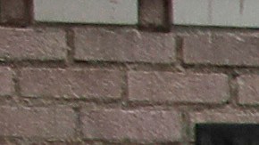 FILE - In this March 20, 2020 file photo a man covers his face with a mask as he walks past tents on skid row, in Los Angeles. A fed-up federal judge says last week's rainstorm created "extraordinarily harsh" conditions for homeless residents of Los Angeles and he has ordered city officials to meet with him this week at a Skid Row shelter to discuss how to address the worsening crisis of people living on the streets. (AP Photo/Marcio Jose Sanchez,File)