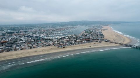 In this aerial image taken with a drone, shows the closed beach after an oil washed up on a beach in Newport Beach, Calif., on Thursday, Oct. 7, 2021. A major oil spill off the coast of Southern California fouled popular beaches and killed wildlife while crews scrambled Sunday, to contain the crude before it spread further into protected wetlands. (AP Photo/Ringo H.W. Chiu)