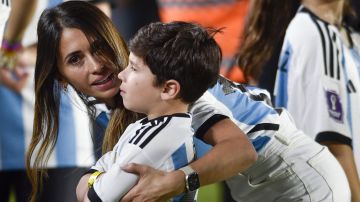 Antonela Roccuzzo, wife of Lionel Messi, embraces their son Mateo prior to an international friendly soccer match between Argentina and Panama in Buenos Aires, Argentina, Thursday, March 23, 2023. (AP Photo/Gustavo Garello)