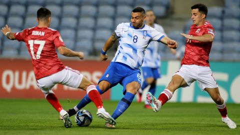 Greece's Giorgos Giakoumakis, center, attempts a shot at goal between Gibraltar's Kian Ronan, left, and Julian Valarino during the Euro 2024 group B qualifying soccer match between Gibraltar and Greece at the Algarve stadium outside Faro, Portugal, Friday, March 24, 2023. (AP Photo/Joao Matos)