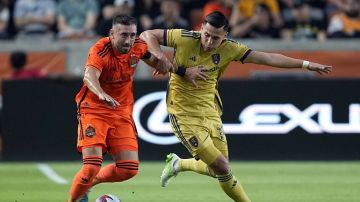 Real Salt Lake's Rubio Rubin (14) challenges Houston Dynamo's Héctor Herrera for the ball during the first half of an MLS soccer match Saturday, May 6, 2023, in Houston. (AP Photo/David J. Phillip)