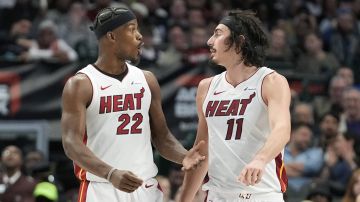 Miami Heat forward Jimmy Butler (22) and Miami Heat guard Jaime Jaquez Jr. (11) discuss a play during the second half of an NBA basketball game against the Dallas Mavericks in Dallas, Thursday, March 7, 2024. (AP Photo/LM Otero)
