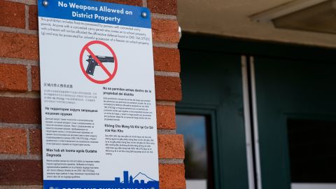 A notice about weapons from the Portland Public Schools is displayed at a school near an entrance door on Friday, April 5, 2024, in Portland, Ore. (AP Photo/Jenny Kane)