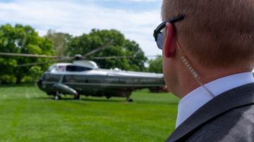 A U.S. Secret Service Special Agent watches as Marine One, with President Joe Biden aboard, prepares to lift off from the South Lawn of the White House, Tuesday, April 30, 2024, in Washington. Biden is headed to Delaware. (AP Photo/Alex Brandon)