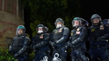 Police line up at an encampment set up by pro-Palestinian demonstrators on the UCLA campus Thursday, May 2, 2024, in Los Angeles. (AP Photo/Jae C. Hong)