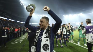 PSG's Kylian Mbappe celebrates PSG's French League One title after the French League One soccer match between Paris Saint-Germain and Toulouse at the Parc des Princes stadium in Paris, Sunday, May 12, 2024. (Franck Fife, Pool via AP)