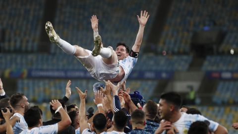 FILE - Teammates toss Argentina's Lionel Messi in the air after beating Brazil 1-0 in the Copa America final soccer match at the Maracana stadium in Rio de Janeiro, Brazil, July 10, 2021. Messi and Argentina will try to win their third straight major title when they defend their Copa America championship while Brazil hopes 17-year-old Endrick will combine with Vinícius Júnior and Rodrygo for success. (AP Photo/Bruna Prado, File)