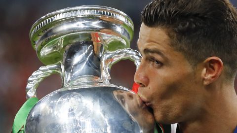 FILE - In this Sunday, July 10, 2016 file photo, Portugal's Cristiano Ronaldo kisses the trophy at the end of the Euro 2016 final soccer match between Portugal and France at the Stade de France in Saint-Denis, north of Paris. The Euros kick off in Munich, Friday June 14, when host country Germany plays Scotland at Bayern Munich's Allianz Arena. The tournament begins with six groups of four teams. (AP Photo/Frank Augstein, File)