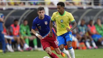 Brazil forward Rodrygo, right, moves the ball past United States forward Christian Pulisic, left, during the first half of an international friendly soccer match Wednesday, June 12, 2024, in Orlando, Fla. (AP Photo/John Raoux)