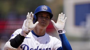 Los Angeles Dodgers' Shohei Ohtani gestures toward his dugout as he rounds third after hitting a solo home run during the third inning of a baseball game against the Kansas City Royals Sunday, June 16, 2024, in Los Angeles. (AP Photo/Mark J. Terrill)