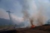 Water is dropped by helicopter as crews fight the Post Fire, Sunday, June 16, 2024, in Lebec, Calif. (AP Photo/Eric Thayer)