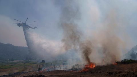 Water is dropped by helicopter as crews fight the Post Fire, Sunday, June 16, 2024, in Lebec, Calif. (AP Photo/Eric Thayer)