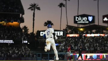 Los Angeles Dodgers designated hitter Shohei Ohtani (17) runs the bases after hitting a home run during the fifth inning of a baseball game against the Los Angeles Angels in Los Angeles, Friday, June 21, 2024. Austin Barnes also scored. (AP Photo/Ashley Landis)