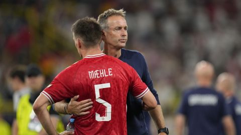 Denmark's head coach Kasper Hjulmand hugs Denmark's Joakim Maehle after a round of sixteen match between Germany and Denmark at the Euro 2024 soccer tournament in Dortmund, Germany, Saturday, June 29, 2024. (AP Photo/Andreea Alexandru)