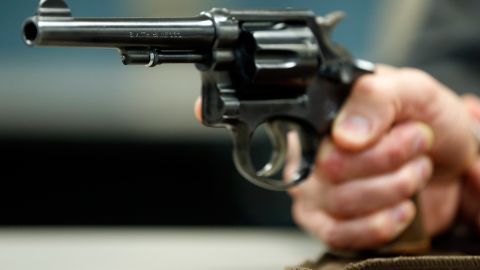 In this Wednesday, March 25, 2015, photo, Internal Revenue Service Special Agent In Charge Jonathan Larsen, holds a Smith & Wesson .38 Special during an interview in Mountainside, N.J. The gun belonged to IRS investigator Michael Malone, the man who went undercover to infiltrate Al Capones gang in the 1930s and eventually brought down the feared mobster. (AP Photo/Julio Cortez)