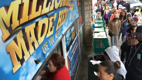 Customers wait in line outside the Blue Bird Liquor store to buy Powerball lottery tickets in Hawthorne, Calif., on Wednesday, Jan. 13, 2016. A lottery official says the estimated Powerball jackpot remains over a billion. (AP Photo/Damian Dovarganes)