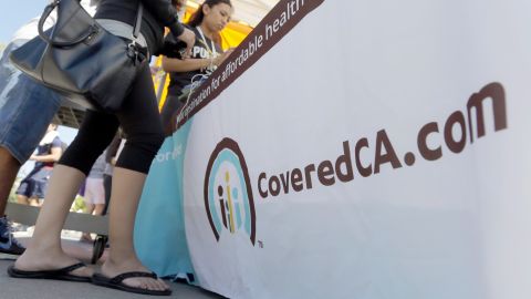 A student peruses information at a table set up by the CSU Health Insurance Project, to provide information about the new health options available, on the campus of California State University-Los Angeles Tuesday, Oct. 1, 2013. Californians who buy their own health insurance and those who have been hoping for coverage began using the state's online marketplace Tuesday after it opened for business on the first day of enrollment. (AP Photo/Reed Saxon)