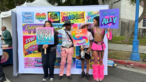 Asistentes a la feria del orgullo en West Hollywood posan en el mural contra el odio.