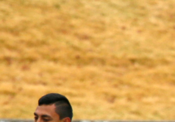 Club America's head coach Ricardo La Volpe, center, walks on the pitch as his players warm up during a training session at the FIFA Club World Cup soccer tournament in Yokohama, near Tokyo, Wednesday, Dec. 14, 2016. Club America and Real Madrid will play in the Dec. 15 semifinal. (AP Photo/Shuji Kajiyama)