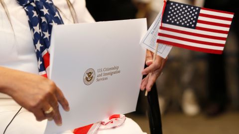 Vivian Ragan holds the envelope containing her United States citizenship papers and an American flag at a naturalization ceremony, Thursday, May 16, 2019, in Centennial, Colo. (AP Photo/David Zalubowski)
