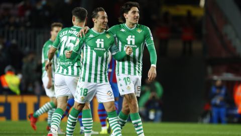 Betis' Andres Guardado and Hector Bellerin celebrate at the end of the Spanish La Liga soccer match between Barcelona and Real Betis at the Camp Nou stadium, in Barcelona, Spain, Saturday, Dec. 4, 2021. Betis won 1-0. (AP Photo/Joan Monfort)