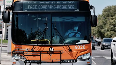 A Los Angeles Metro bus with an electronic display requiring a face mask is seen as the driver pulls out of a bus stop in Los Angeles on Tuesday, April 19, 2022. A federal judge's decision to strike down a national mask mandate was met with cheers on some airplanes but also concern about whether it's really time to end the order sparked by the COVID-19 pandemic. (AP Photo/Richard Vogel)