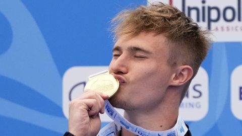 Jack Laugher of Britain celebrates on the podium after winning the gold medal in the Men's diving 1m springboard final at the European swimming championships, in Rome, Thursday, Aug. 18, 2022. (AP Photo/Gregorio Borgia)