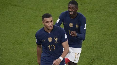 France's Kylian Mbappe celebrates after scoring his side's second goal with France's Ousmane Dembele during the World Cup round of 16 soccer match between France and Poland, at the Al Thumama Stadium in Doha, Qatar, Sunday, Dec. 4, 2022. (AP Photo/Christophe Ena)