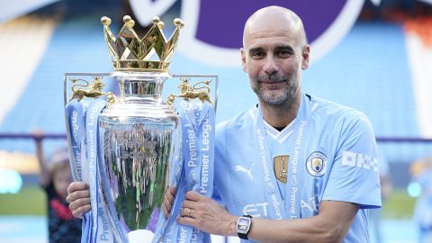 Manchester City's head coach Pep Guardiola celebrates with the Premier League trophy after the English Premier League soccer match between Manchester City and West Ham United at the Etihad Stadium in Manchester, England, Sunday, May 19, 2024. Manchester City clinched the English Premier League on Sunday after beating West Ham in their last match of the season. (AP Photo/Dave Thompson)