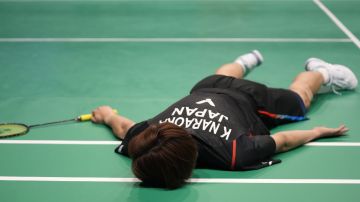 Japan's Kodai Naraoka lies facedown on the court after losing a point to Lee Zii Jia of Malaysia during the men's singles final badminton match at the Australian Open in Sydney, Sunday, June 16, 2024. (AP Photo/Rick Rycroft)