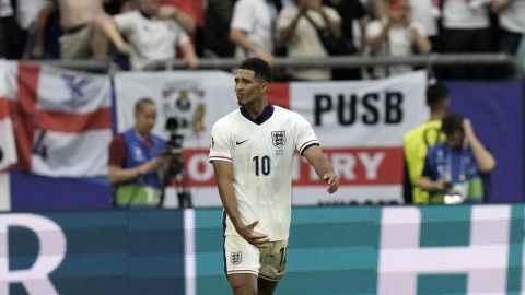 EDS NOTE: OBSCENITY - England's Jude Bellingham gestures after scoring his side's first goal during a round of sixteen match between England and Slovakia at the Euro 2024 soccer tournament in Gelsenkirchen, Germany, Sunday, June 30, 2024. Bellingham is being investigated by UEFA over a potentially offensive gesture made during a European Championship win against Slovakia. . (AP Photo/Thanassis Stavrakis)